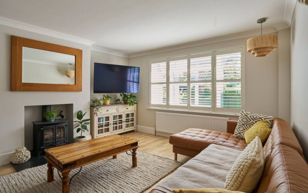 A living room with interior shutters on the window at Marksons Furniture & Windows near Grand Cayman Islands